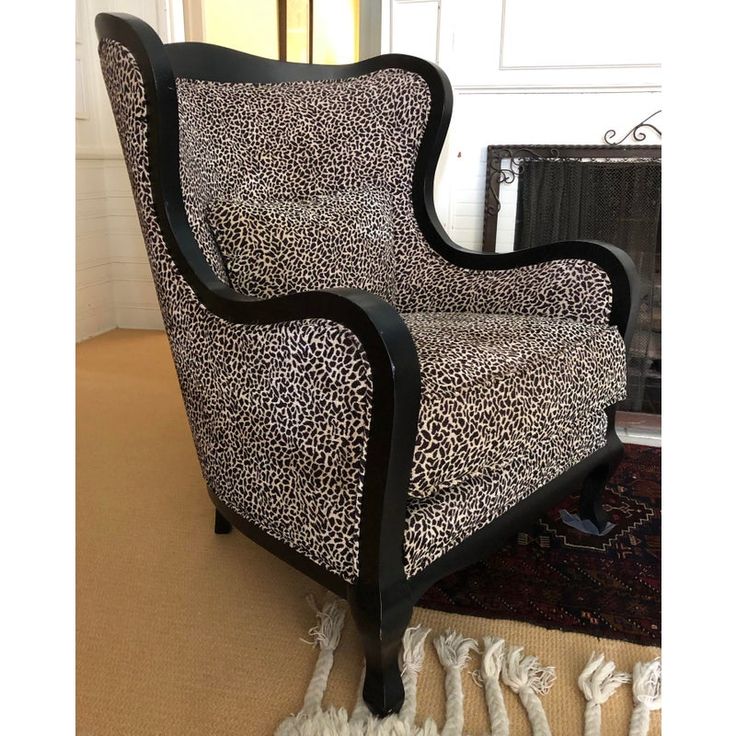 a leopard print chair sitting on top of a rug