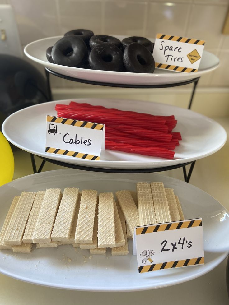 three plates with different types of donuts on top of each plate, and one has labels that read 2x1s