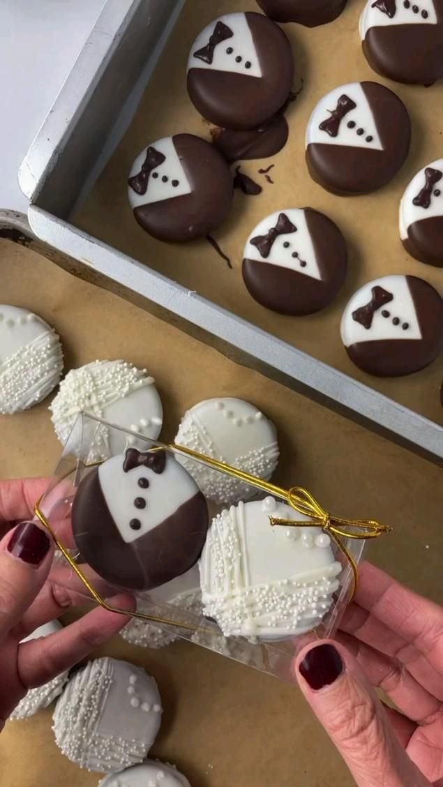 chocolate covered heart shaped pastries are being held by someone's hand in front of them