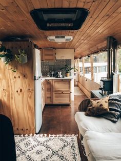 the interior of a small home with wood paneling on the walls and ceiling,