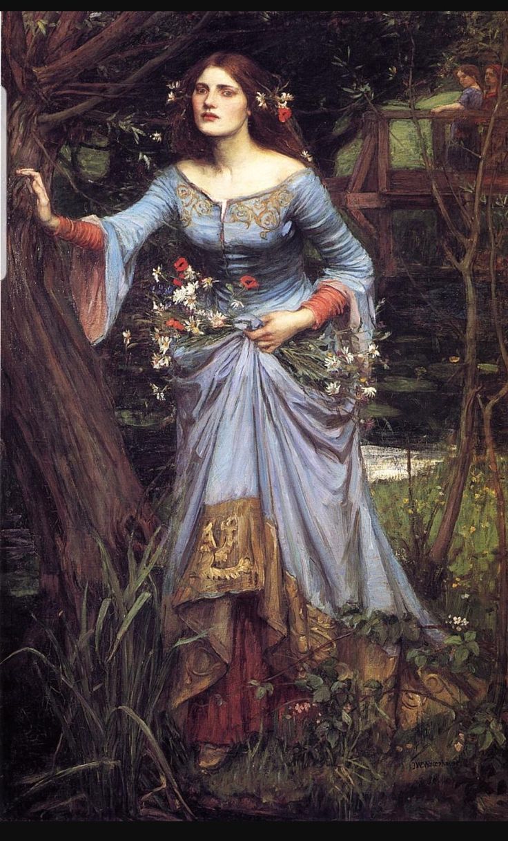 a woman in a dress standing next to a tree