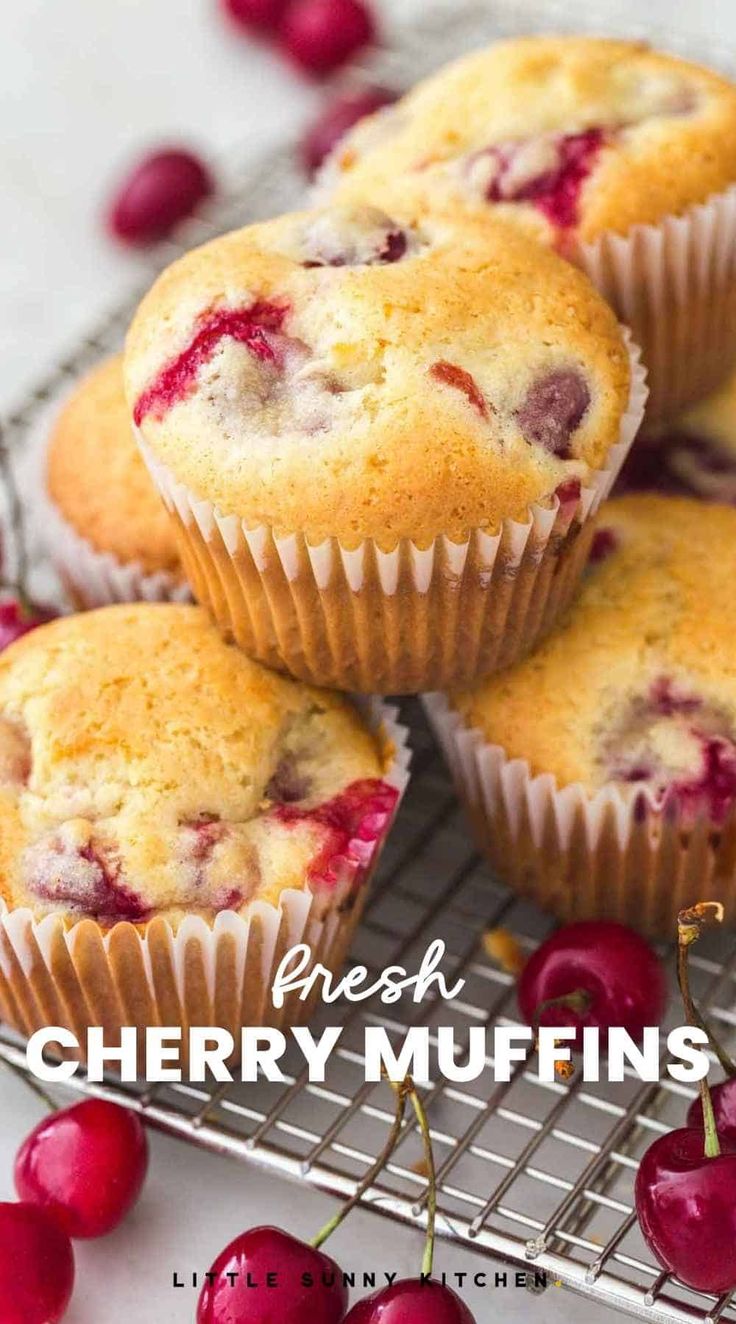 fresh cherry muffins on a cooling rack with cherries