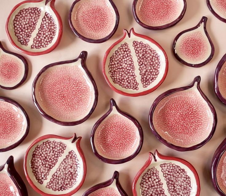 a group of cut up pieces of fruit sitting on top of each other in the shape of pomegranates