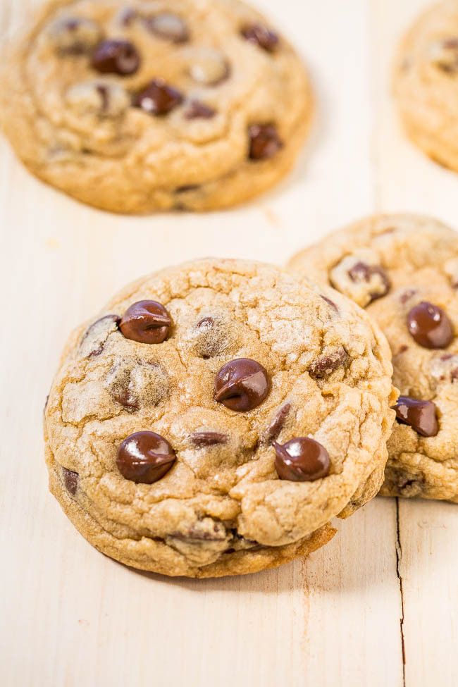 several chocolate chip cookies on a wooden surface