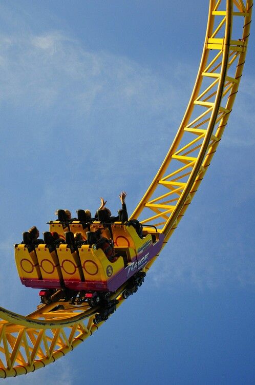 a roller coaster with people riding it in the sky