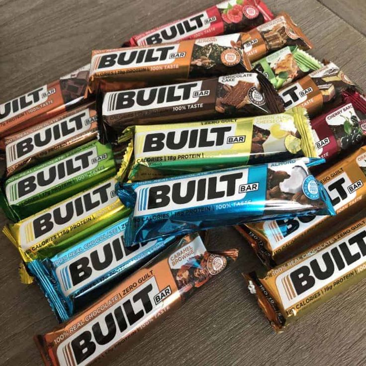 a pile of multi - colored bars sitting on top of a wooden table next to each other