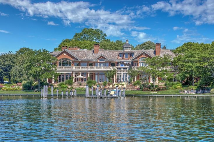 a large house sitting on top of a lake