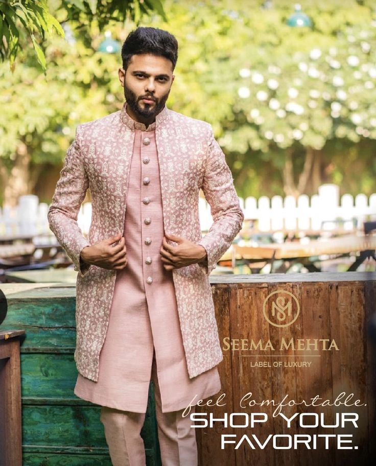 a man in a pink suit standing next to a wooden box with the words shop your favorite