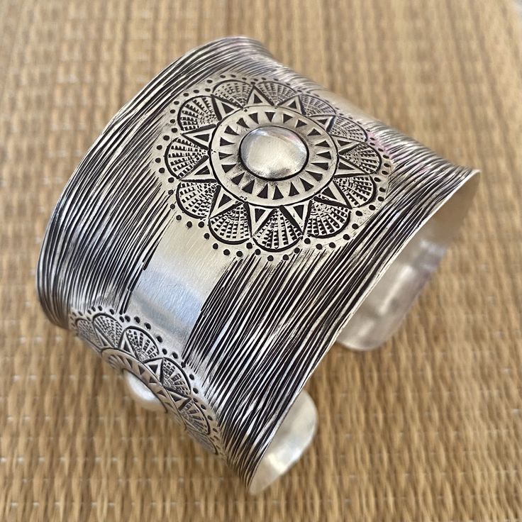 "❋ Handmade Sterling Silver Wide Boho Statement Cuff with Engraved Oxidized Silver Solar Mandala ❋ Dimensions: Width: About 1.5\" (3.8 cm), Length: About 6.9\" / 17.5cm ❋ Metal Purity: 95% Pure Silver (Purer than 925 Sterling Silver) To browse some more of our Silver Jewelry collection you can click on the following links: https://www.etsy.com/shop/SilverShapes Earrings: https://www.etsy.com/shop/SilverShapes?section_id=14809462&ref=shopsection_leftnav_1 Rings: https://www.etsy.com/shop/Silv Adjustable Etched Bangle For Ceremonial Wear, Adjustable Etched Bangle For Ceremonial Occasions, Ceremonial Etched Adjustable Bangle, Ceremonial Adjustable Etched Bangle, Artisan Adjustable Bangle For Festivals, Bohemian Wide Band Engraved Jewelry, Adjustable Cuff Bangle For Ceremonial Occasions, Bohemian Cuff Bracelet For Festivals With Intricate Design, Bohemian Cuff Bracelet With Intricate Design For Festivals