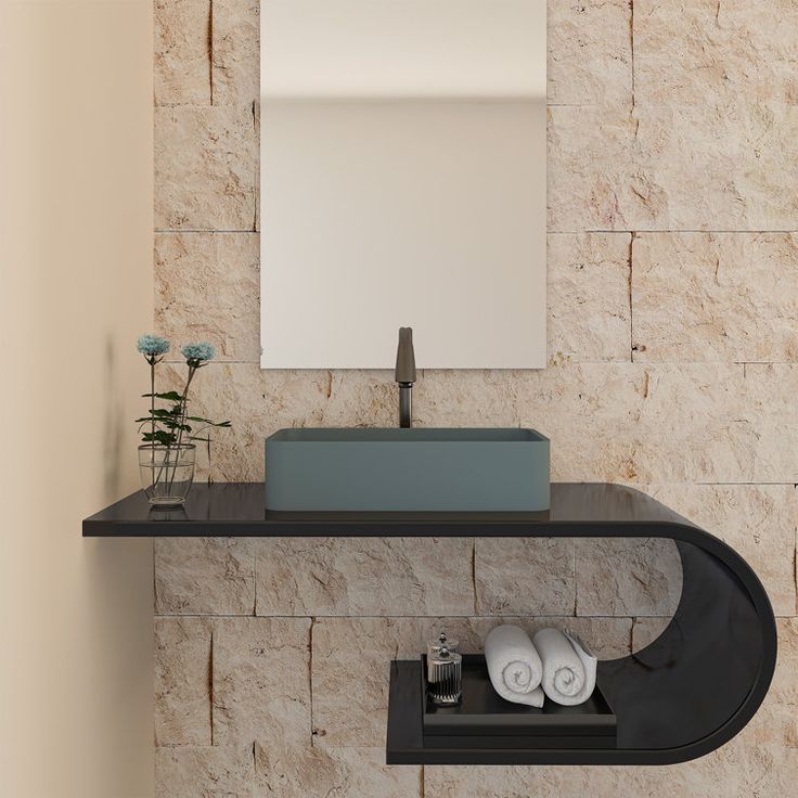 a bathroom with a sink, mirror and towels on the shelf in front of it