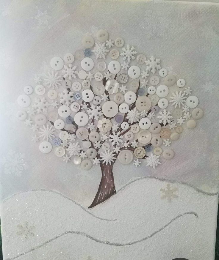 a white card with buttons on it and a tree in the middle, surrounded by snowflakes