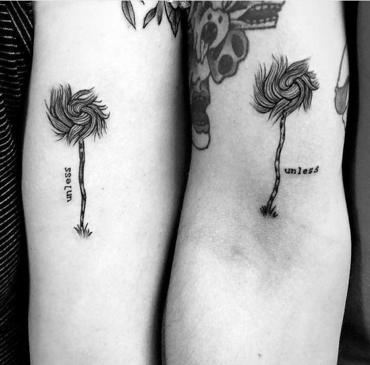 two people with matching tattoos on their arms