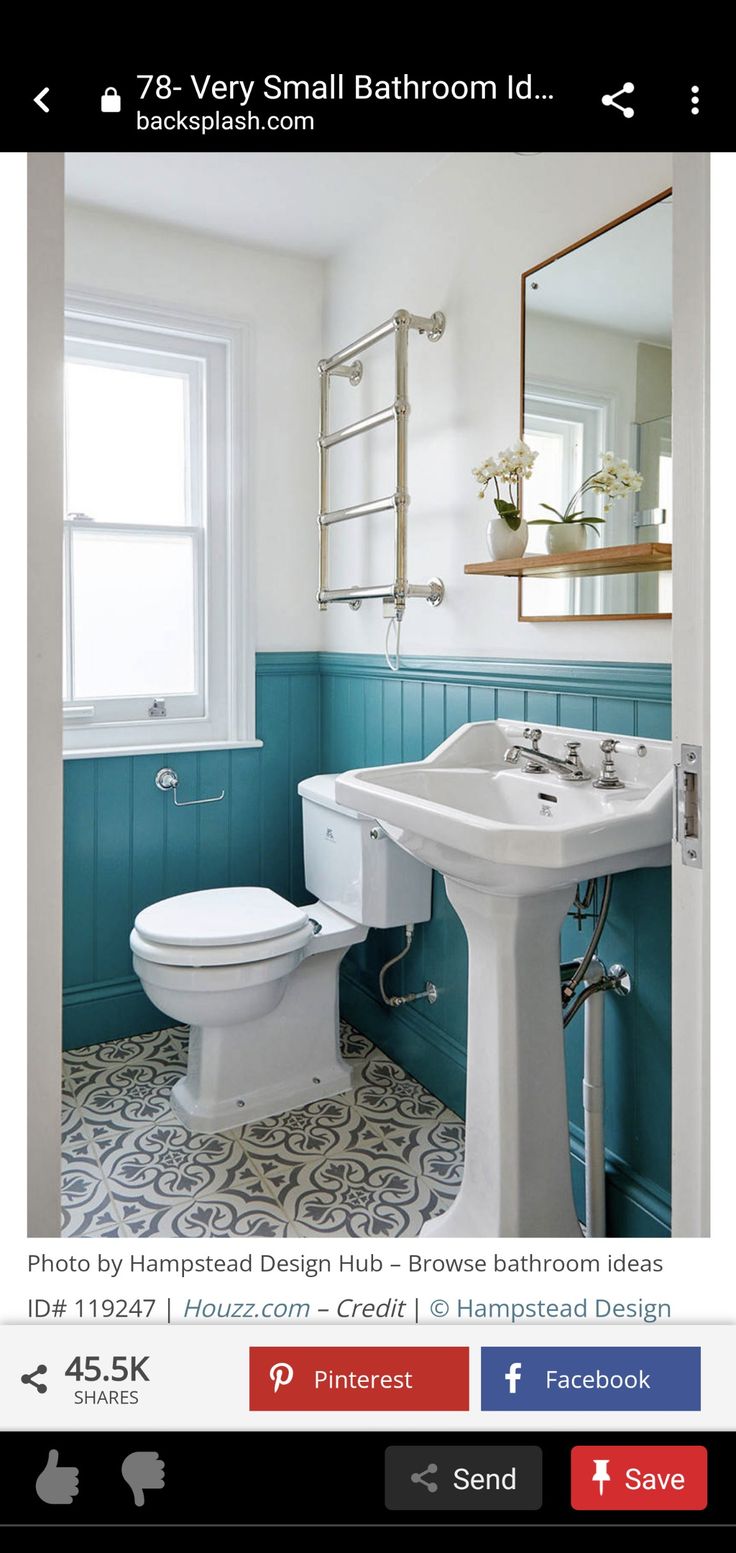 a white toilet sitting next to a sink in a bathroom under a window with blue walls