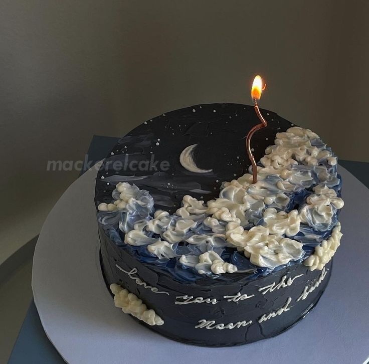 a blue and white cake with a candle on top