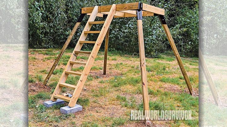 a wooden swing set with ladders in the grass