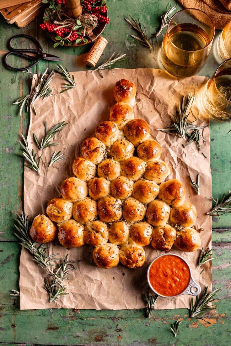 a christmas tree made out of rolls and sauce on top of a piece of paper