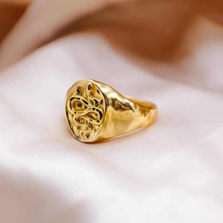 The Hammered Snake Signet ring promises to make a statement. In Ancient Greece snakes were associated with protection and healing and were used Greek mythology to represent renewal & growth. Let your snake signet ring bring you strength on all of your adventures. 925 sterling silver with extra thick 14k gold platingSignet Height 13mm x 10mm Ancient Currency, Autumn 23, Serpent Ring, Silver Coin Necklace, Double Chain Necklace, Fresh Meat, Gold Signet Ring, Snake Ring, Demi Fine Jewelry