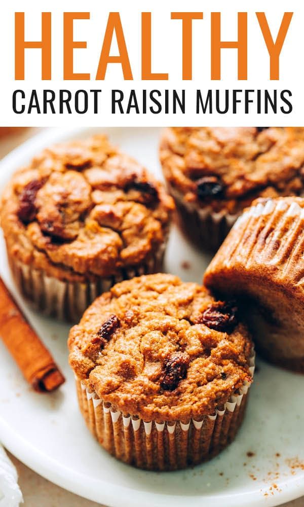 healthy carrot raisin muffins on a white plate with cinnamon sticks in the background