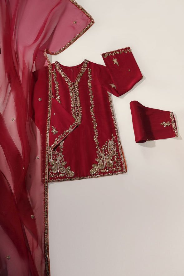 A beautiful festive look in the captivating shade of burnt orange, crafted on pure raw silk in a long kameez silhouette, heavily embellished with gold zardozi craftsmanship, each stitch is a testament to generations of artistry. Completing this masterpiece of a design is a fully embellished soft pure organza dupatta, a Transitional Red Raw Silk Kurta, Transitional Red Sharara With Dabka Details, Red Raw Silk Kurta With Traditional Drape, Designer Red Raw Silk Kurta, Red Silk Salwar Kameez With Resham Embroidery, Red Silk Churidar With Resham Embroidery, Transitional Raw Silk Kurta With Dupatta, Red Raw Silk Churidar With Traditional Drape, Red Churidar With Dabka Work For Transitional Season