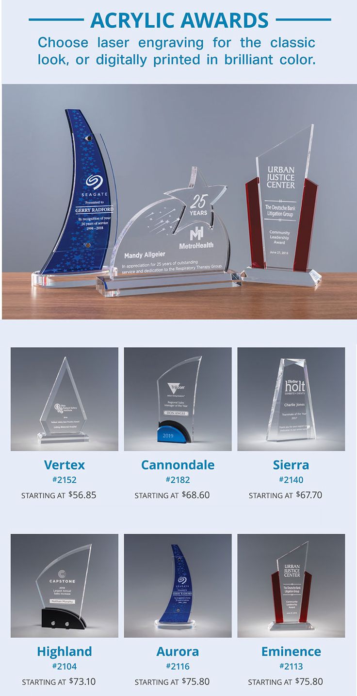 several awards are displayed on a table with the words acrylic awards above them