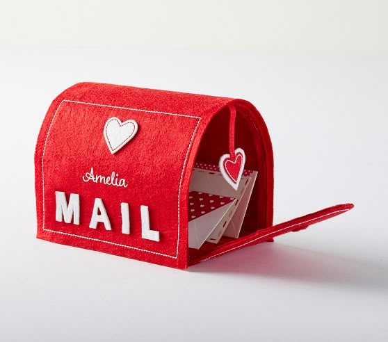 a red mailbox with hearts on it and the word mail written in white letters