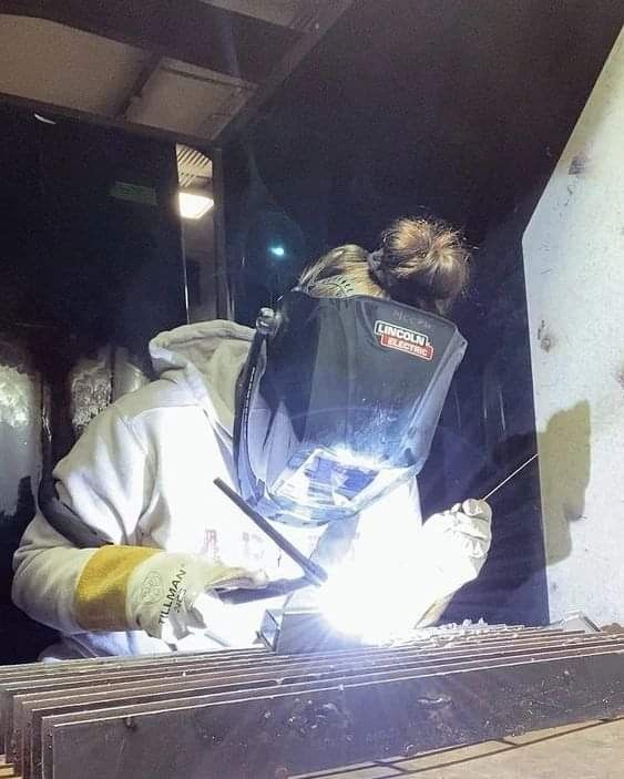 welder working on an item in a factory