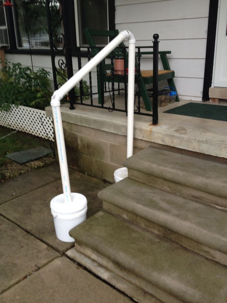 a bucket is sitting on the steps in front of a house