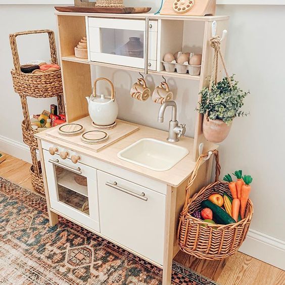 a toy kitchen with a sink, microwave and shelves