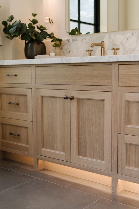 a bathroom with two sinks and a large mirror