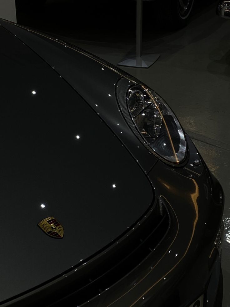 the front end of a black sports car