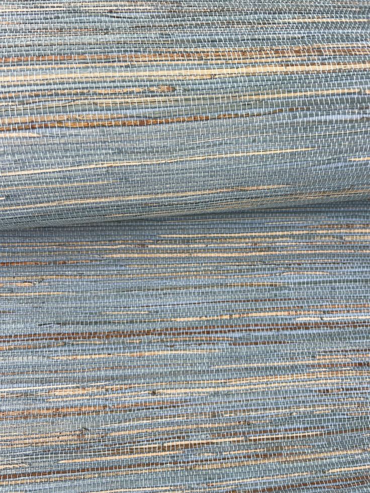 a close up shot of a blue and tan wallpaper with vertical stripes on it