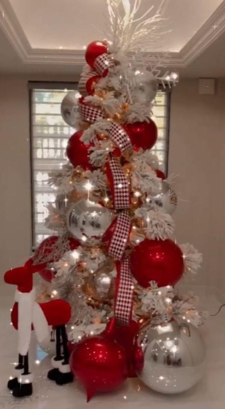 a christmas tree with red and silver ornaments