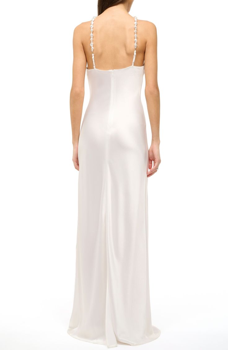 This simply elegant satin gown is designed with beaded straps and sleek cutaway shoulders. 64" length (size 8) Back zip closure V-neck Sleeveless, with cutaway shoulders 100% polyester Dry clean Imported Formal Spaghetti Straps Evening Dress With Bias Cut, Formal Spaghetti Strap Bias Cut Evening Dress, Bias Cut Spaghetti Straps Evening Dress For Formal Events, Fitted Sleeveless Gown With Satin Finish, Formal Gown With Spaghetti Straps And Bias Cut, Formal Gown With Bias Cut And Spaghetti Straps, Glamorous Sleeveless Gown With Satin Finish, Full-length Satin Slip Dress For Evening, Full Length Satin Slip Dress For Evening