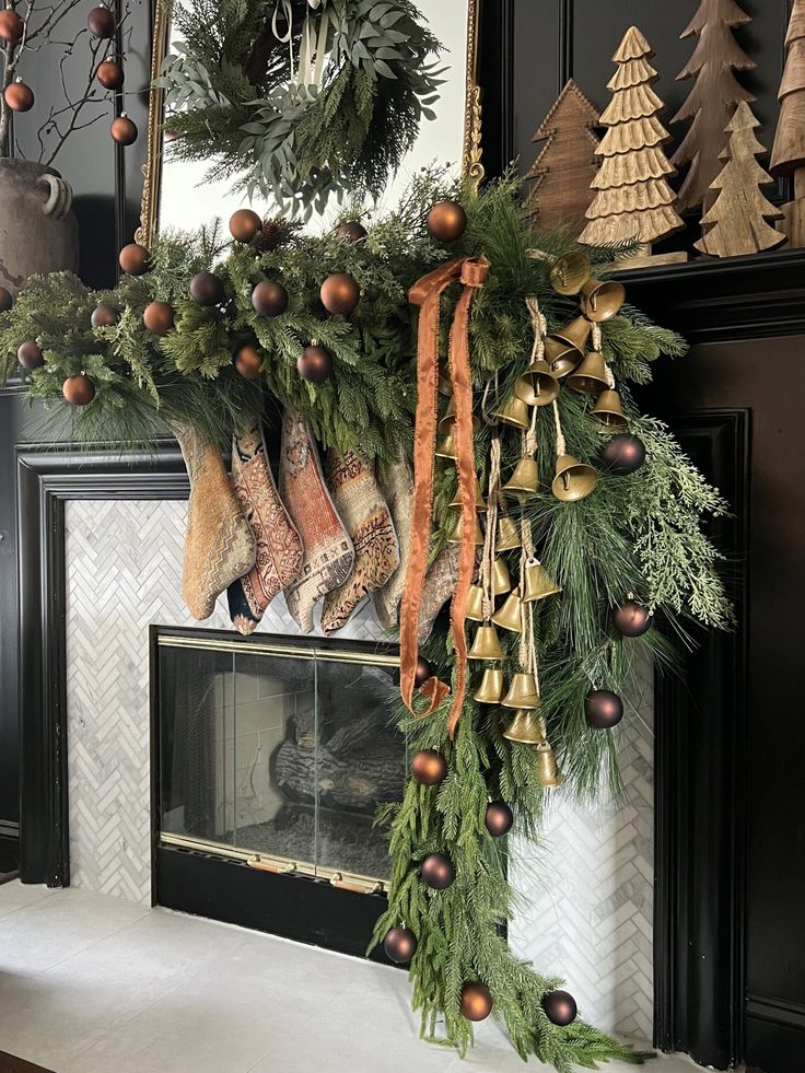 stockings hanging from a mantle decorated for christmas