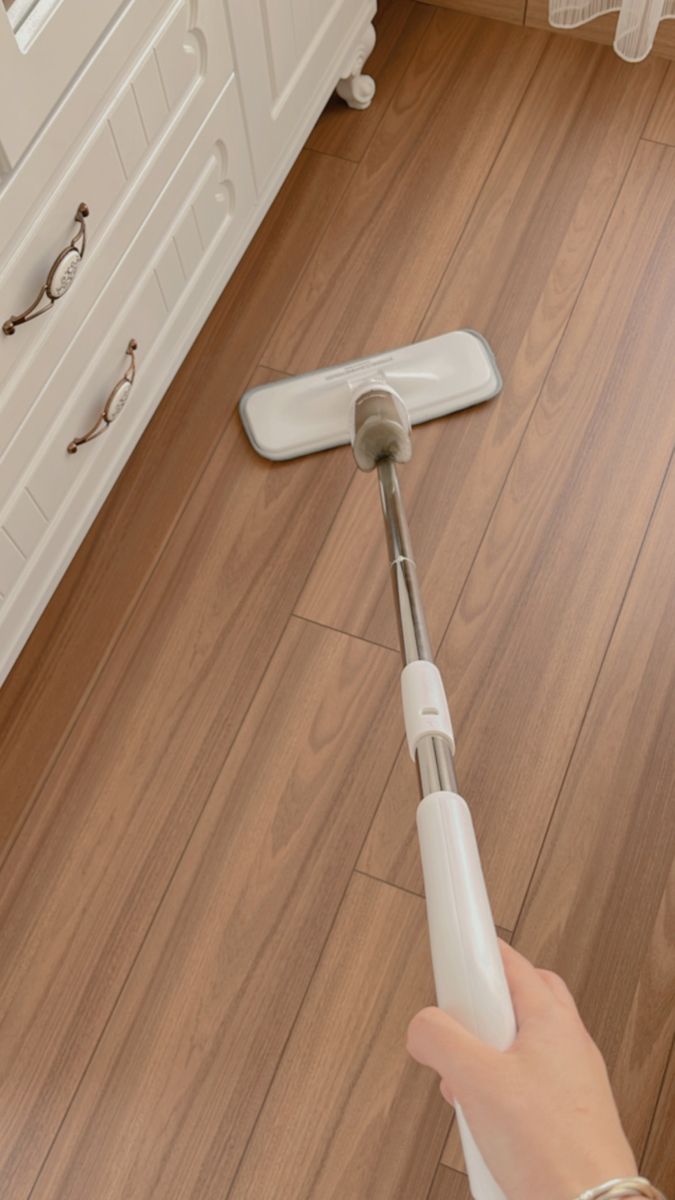 a person is using a mop on the floor