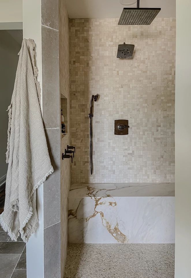 a bath room with a shower and a towel hanging on the wall next to it