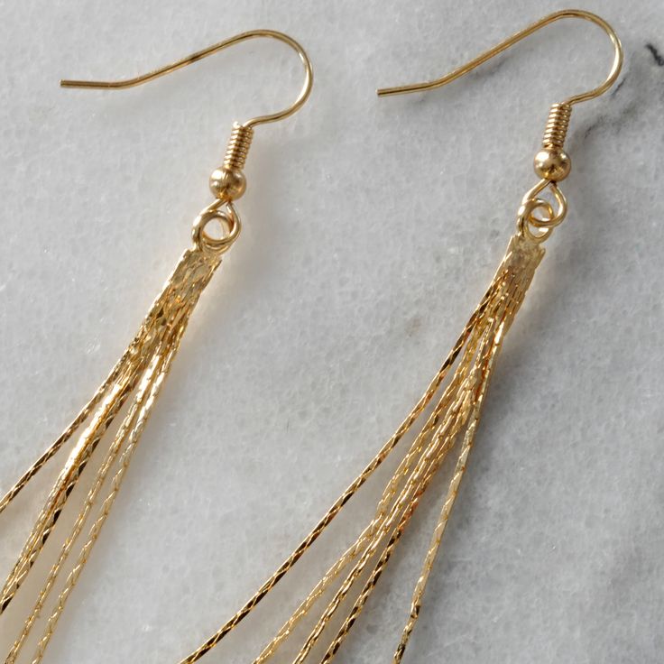 With these slim snake chain earrings, a little shimmer of gold will peek out from your hair offering a retro disco vibe that's also simply modern. gold-plated chain tassel gold-plated stainless steel ear wire hooks lead-free and nickel-free 3.25 inches long packaged on a hand-stamped kraft earring card in a clear resealing bag Elegant Gold Tassel Earrings With Ear Wire, Gold Tassel Dangle Earrings, Minimalist Tassel Dangle Earrings, Minimalist Gold Tassel Drop Earrings, Elegant Nickel-free Tassel Earrings As Gift, Minimalist Party Tassel Drop Earrings, Minimalist Tassel Drop Earrings For Parties, Elegant Nickel-free Tassel Earrings For Gift, Gold Long Drop Tassel Earrings