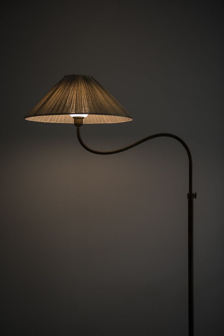 a lamp that is sitting on top of a table next to a light bulb in the dark