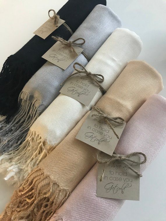 four different colors of scarves with tags on them