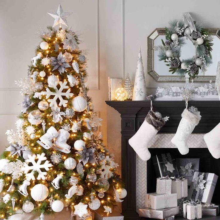 a decorated christmas tree next to a fireplace