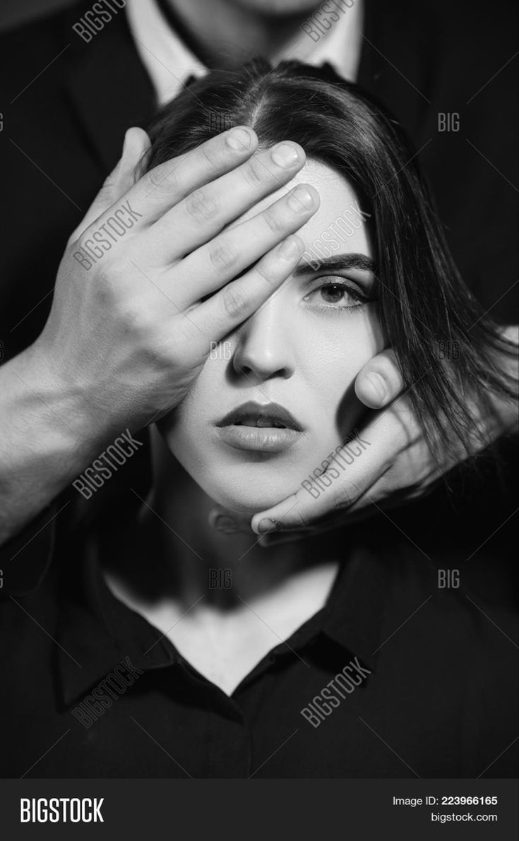 black and white photo of a woman covering her eyes