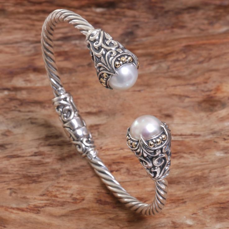 Two silvery white mabe pearls nearly kiss in this elegant cuff bracelet. Drawing inspiration from her Balinese surroundings, artisan Kadek Hendra handcrafts the cuff from sterling silver, creating a rope design with floral details and 18k gold accents at each end. Bracelet Drawing, Pearl Cocktail Ring, Wire Jewelry Patterns, Pearl Cuff Bracelet, Pearl Cuff, Mabe Pearl, Floral Bracelet, Sterling Silver Cuff Bracelet, Rope Design