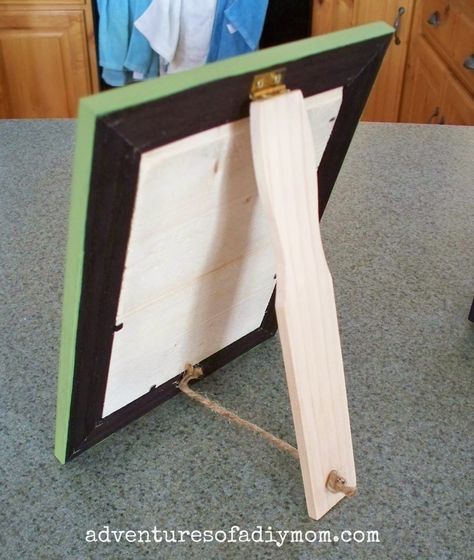 a wooden frame sitting on top of a kitchen counter next to a pair of scissors