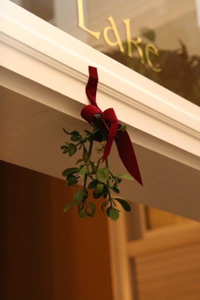 a red ribbon tied to the side of a window sill that says, love