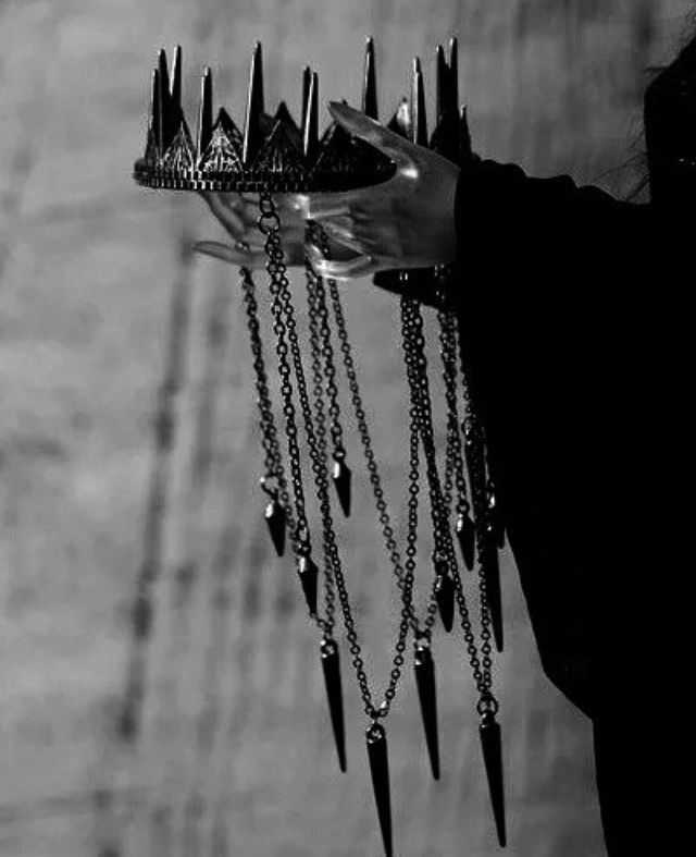 black and white photograph of a woman holding a tray with spikes on it