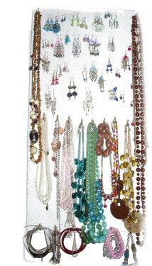 a rack with lots of jewelry hanging from it's sides on a white wall