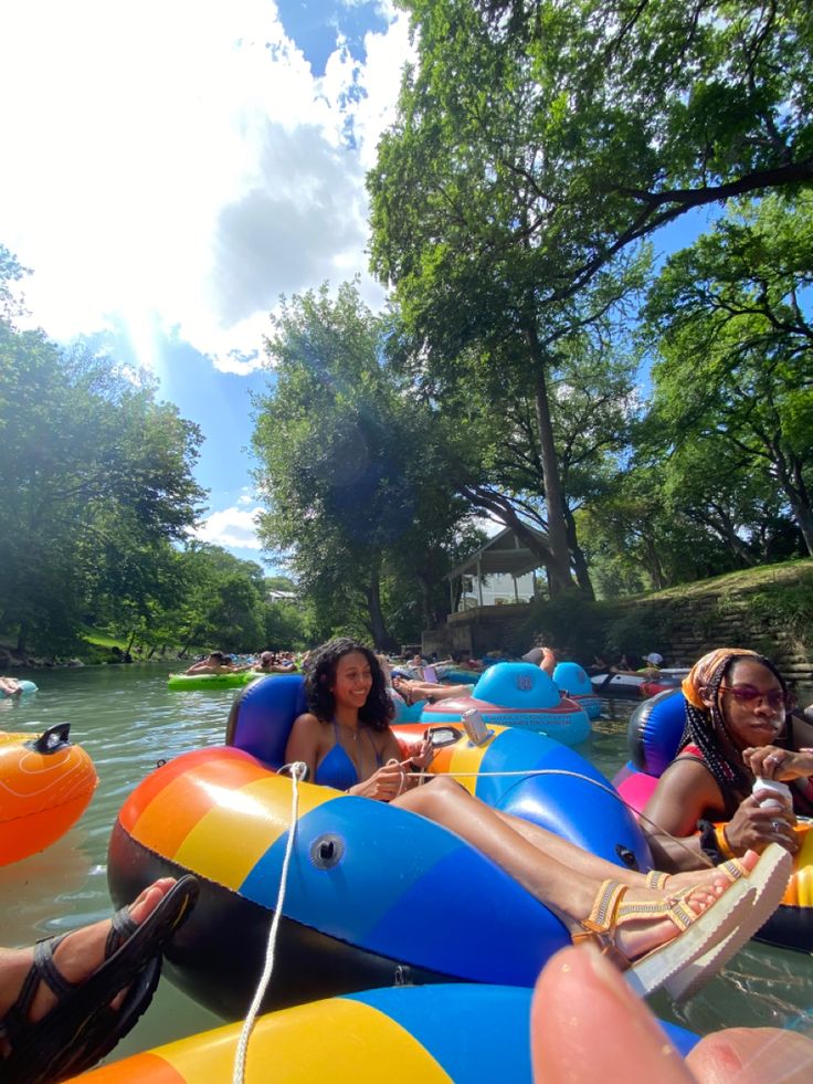 several people are floating on inflatable rafts and having fun with each other