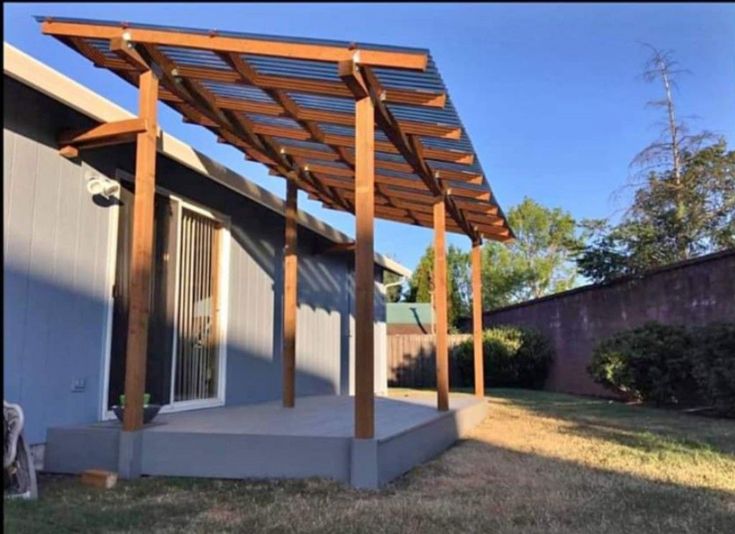 a pergolated covered patio in the back yard