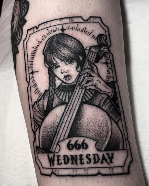 a black and white photo of a woman with a violin tattoo on her arm that says, 60 wednesday