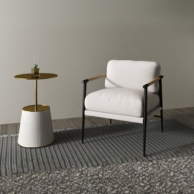 a white chair sitting next to a table on top of a carpeted floor in front of a wall